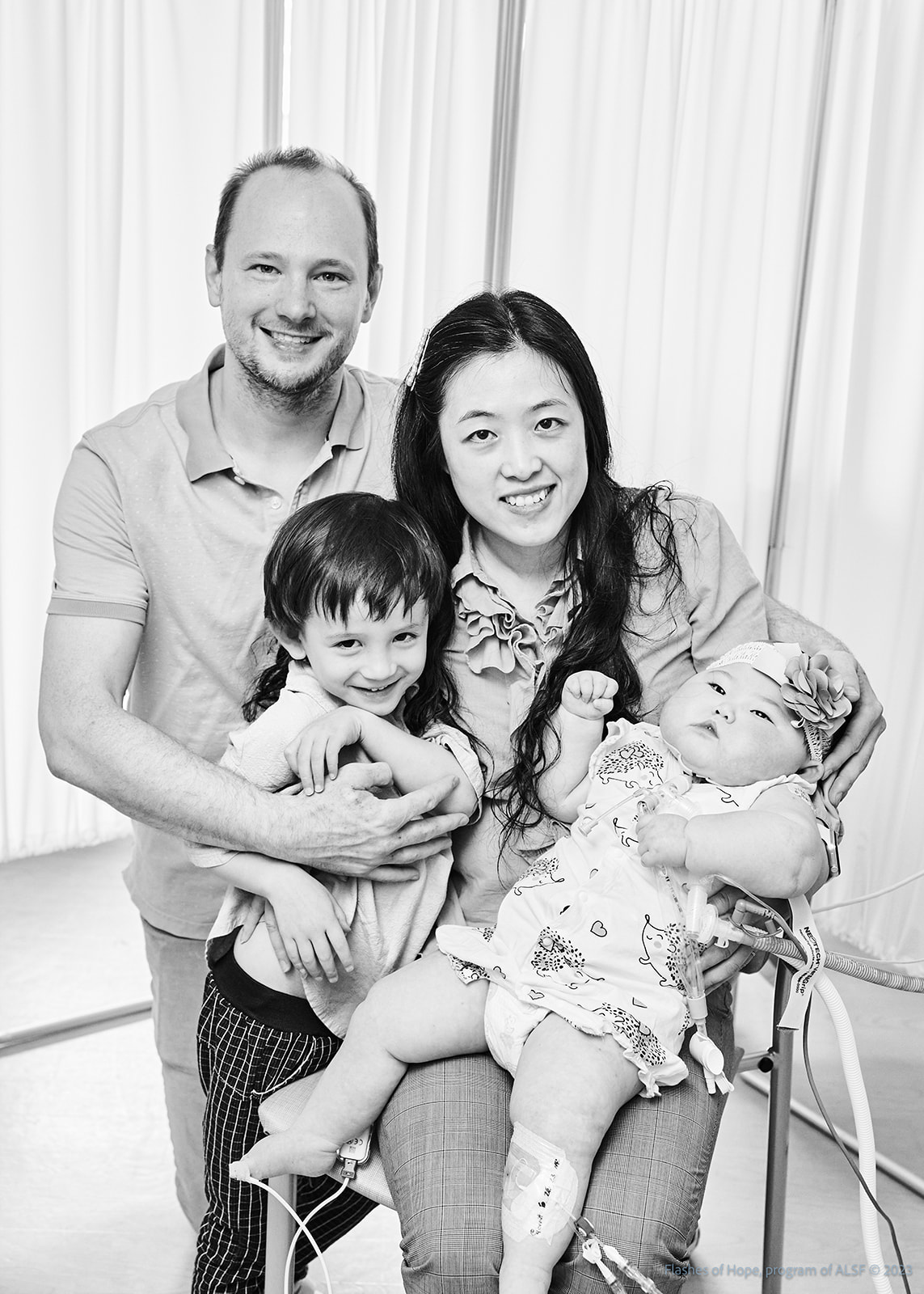 Black and white of Daddy, Mommy, Declan, and Constance sitting.